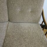 Two-seater rattan sofa with natural tones