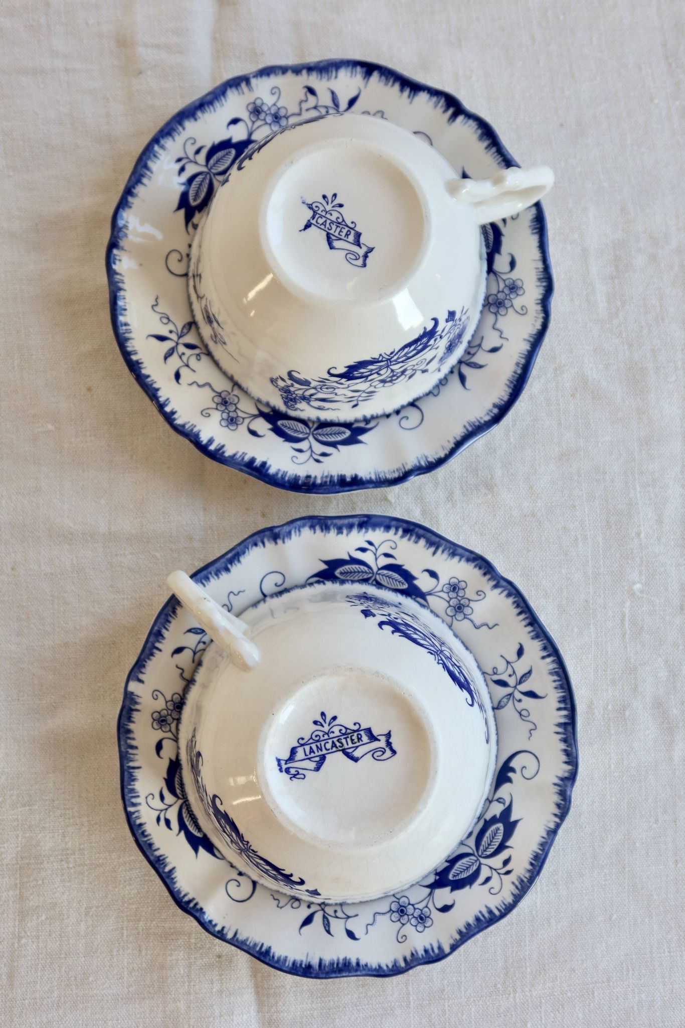 Old Lancaster cups and saucers in white earthenware with blue decoration.