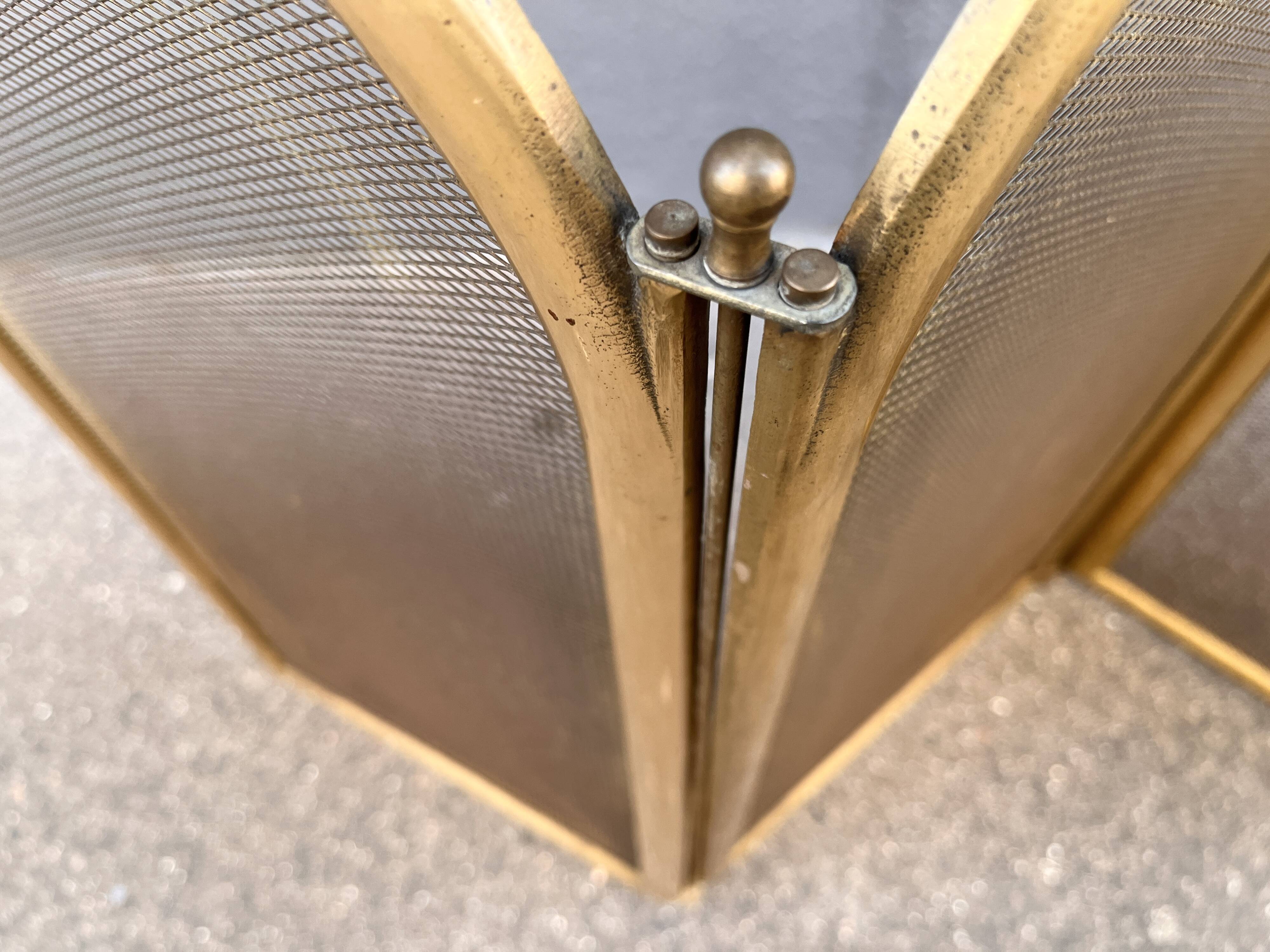 Antique brass fireplace screen from 1920, vintage spark guard.