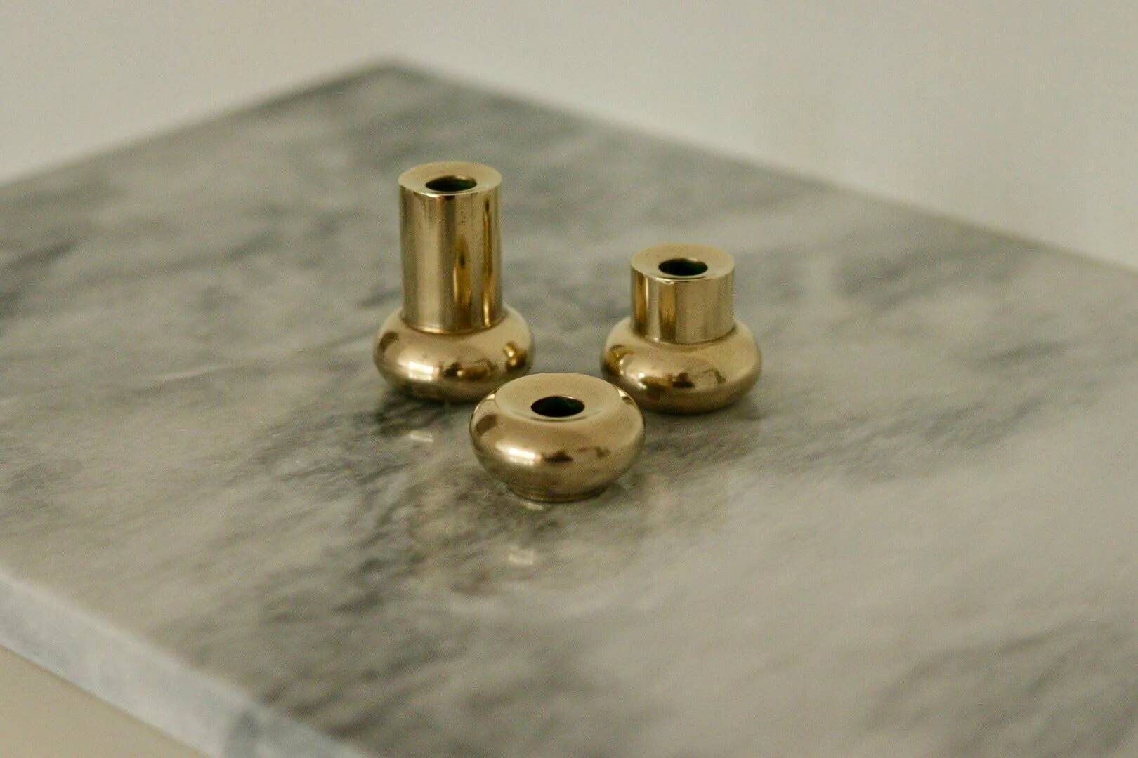Trio of mid-century Swedish brass candle holders