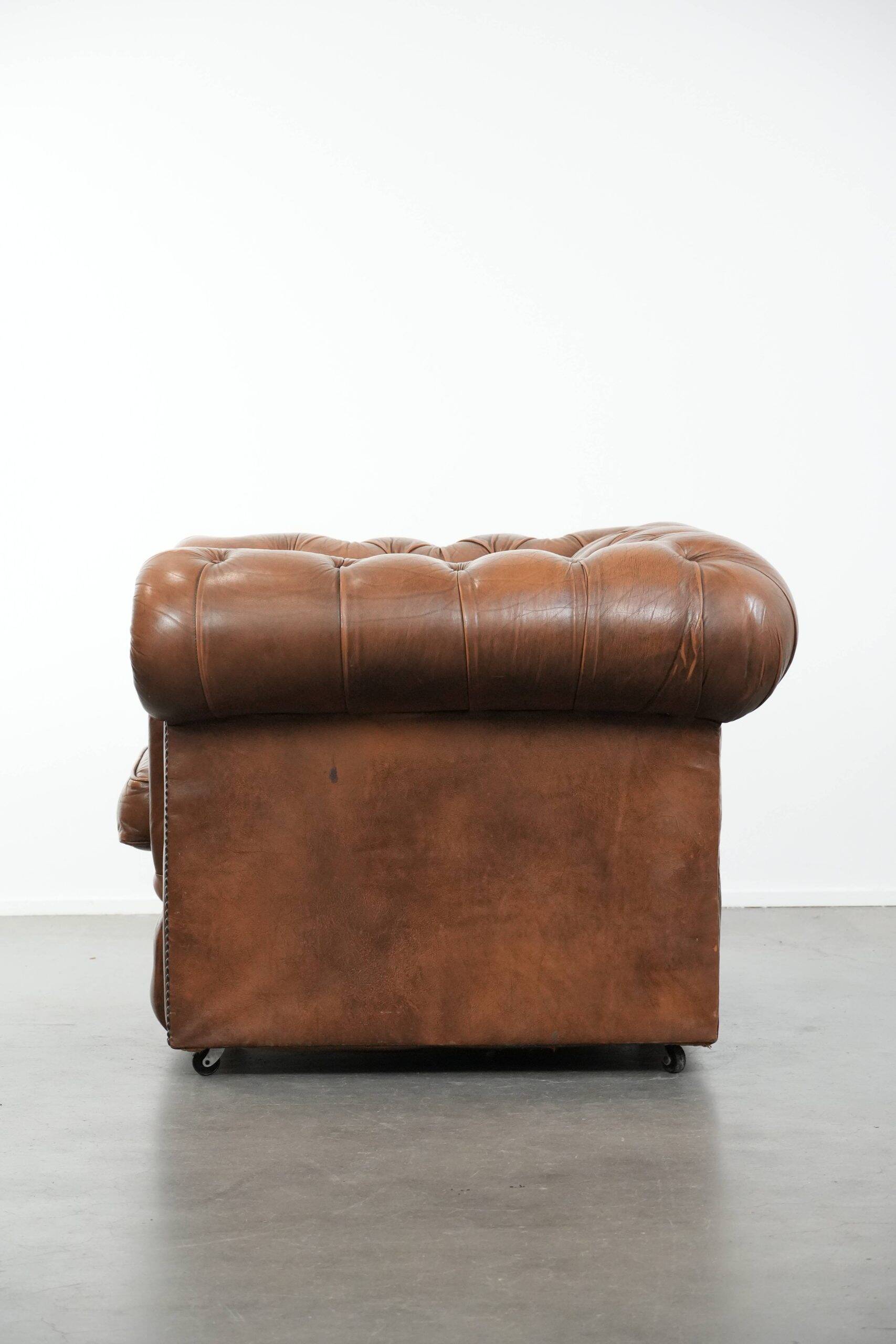 Brown cowhide leather chesterfield armchair  in English style on wheels