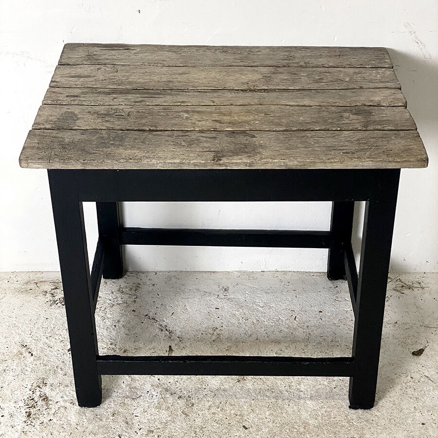 Old blackened wood work table and varnished top