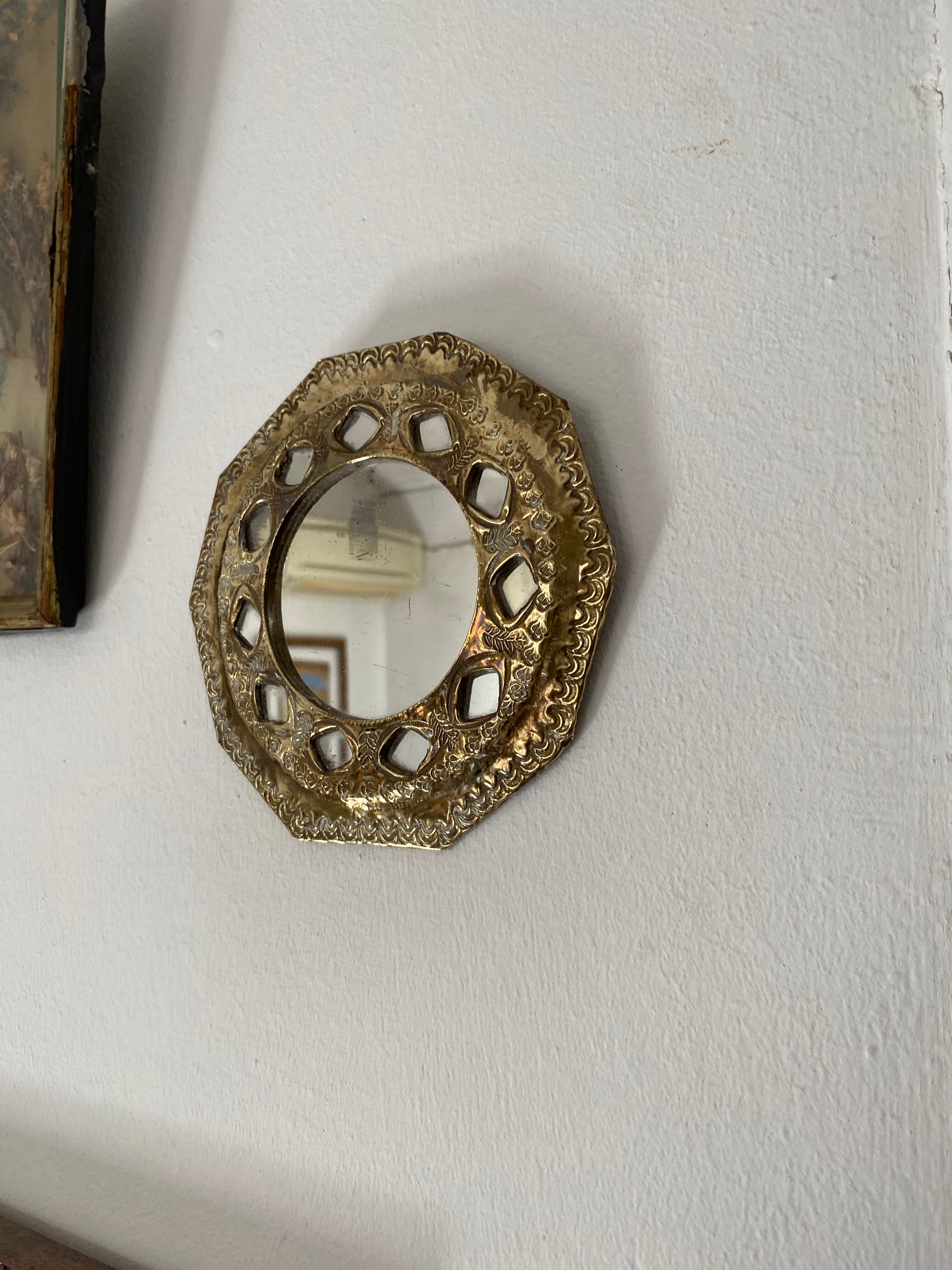 Antique mirror in worked brass