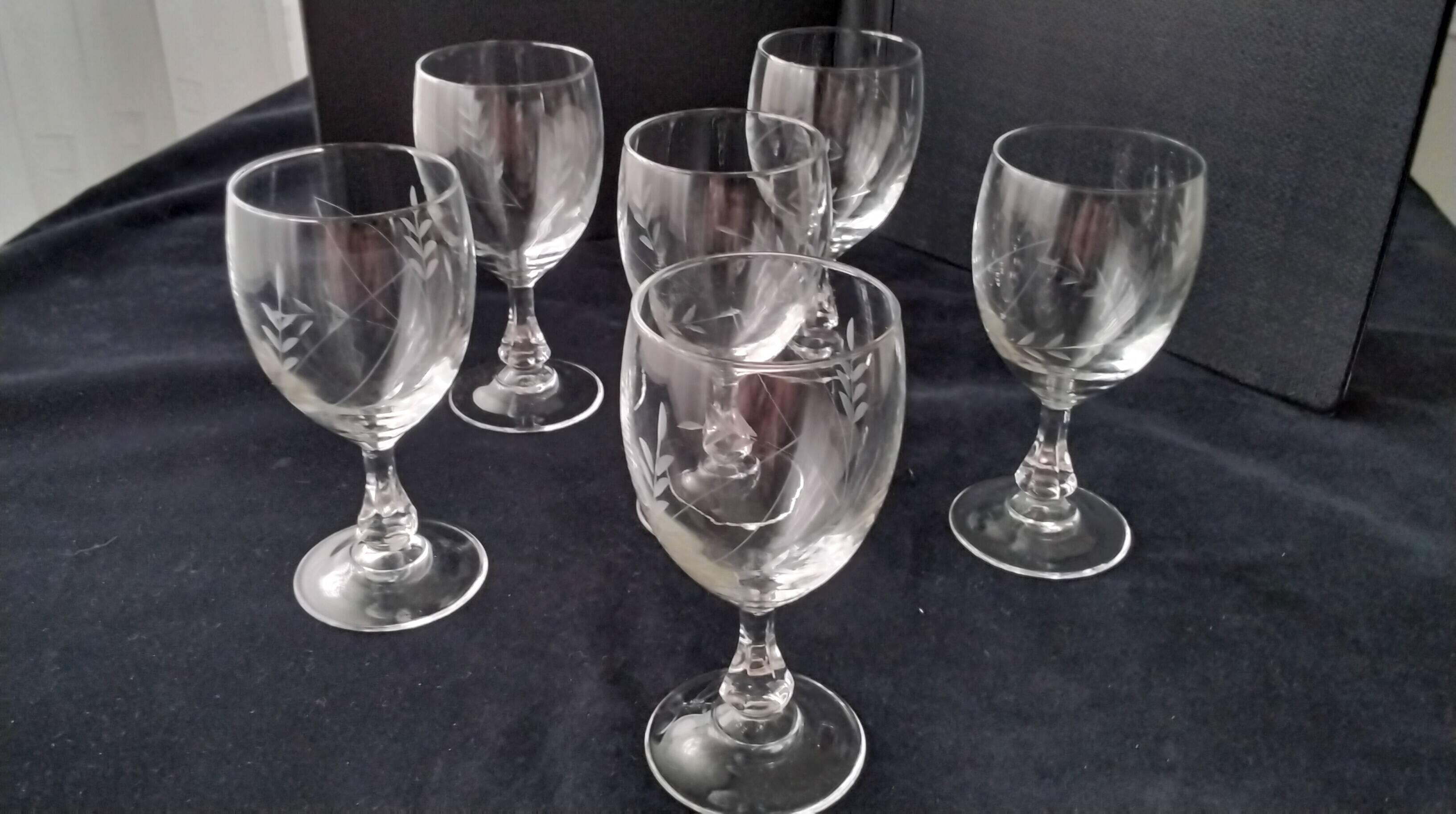 6 vintage wine glasses with baluster stems and engraved decoration on the bowl.