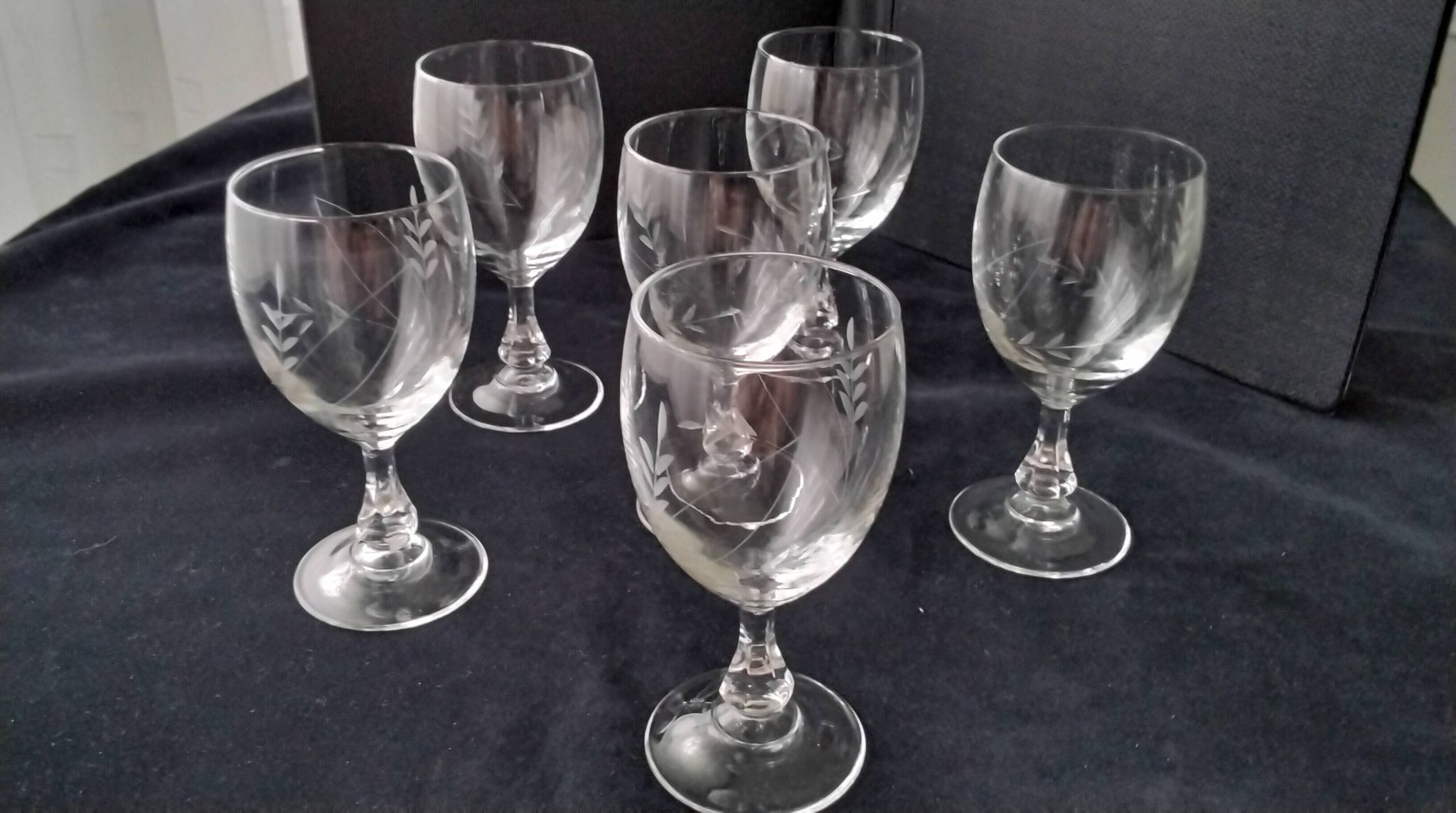 6 vintage wine glasses with baluster stems and engraved decoration on the bowl.