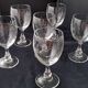 6 vintage wine glasses with baluster stems and engraved decoration on the bowl.