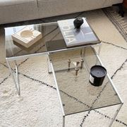 Set of 2 vintage nesting coffee tables in chrome metal and smoked glass.