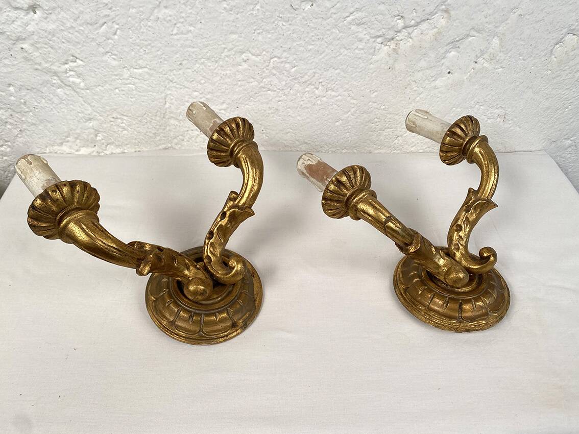 Pair of gilded wooden wall lights with two arms, early 20th century.