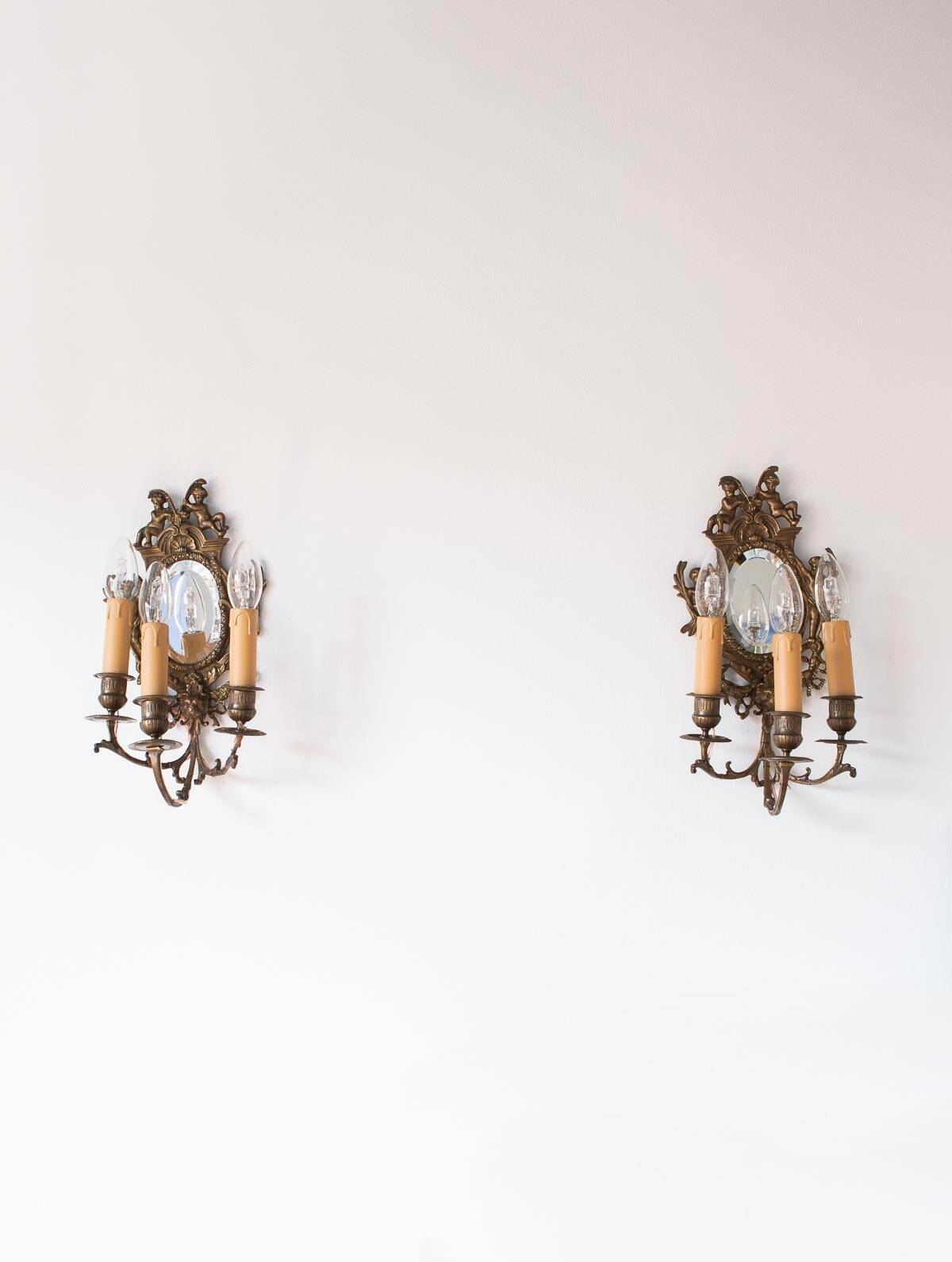 Pair of old French wall lights with beveled mirror and putti