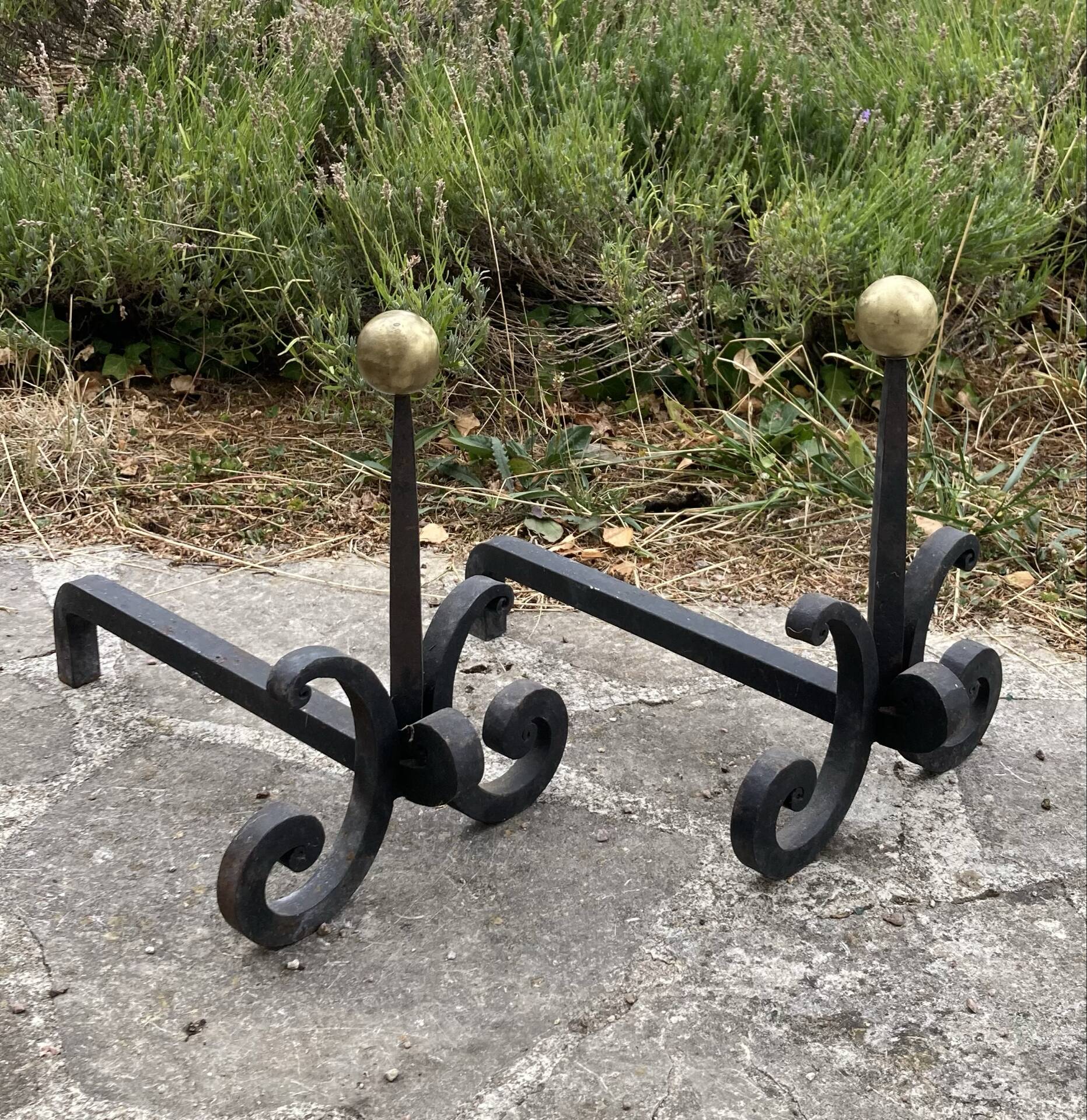 Massive wrought iron chenets from the 19th century topped with brass balls.