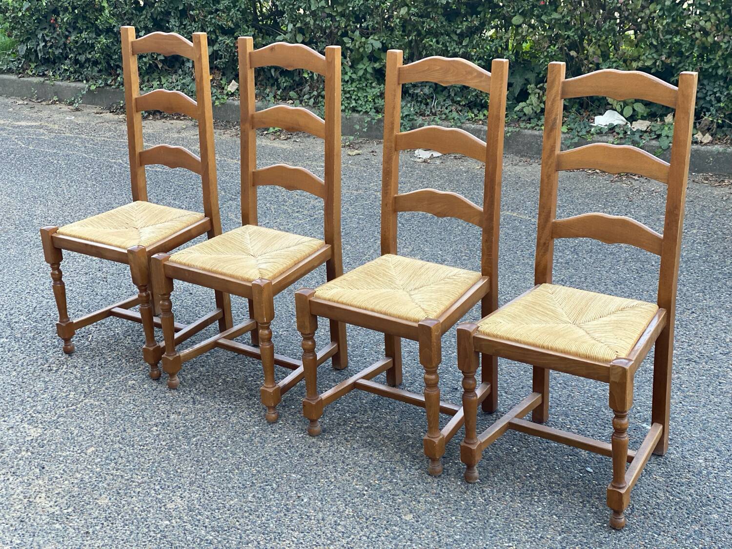 4 straw and solid wood chairs with high backs