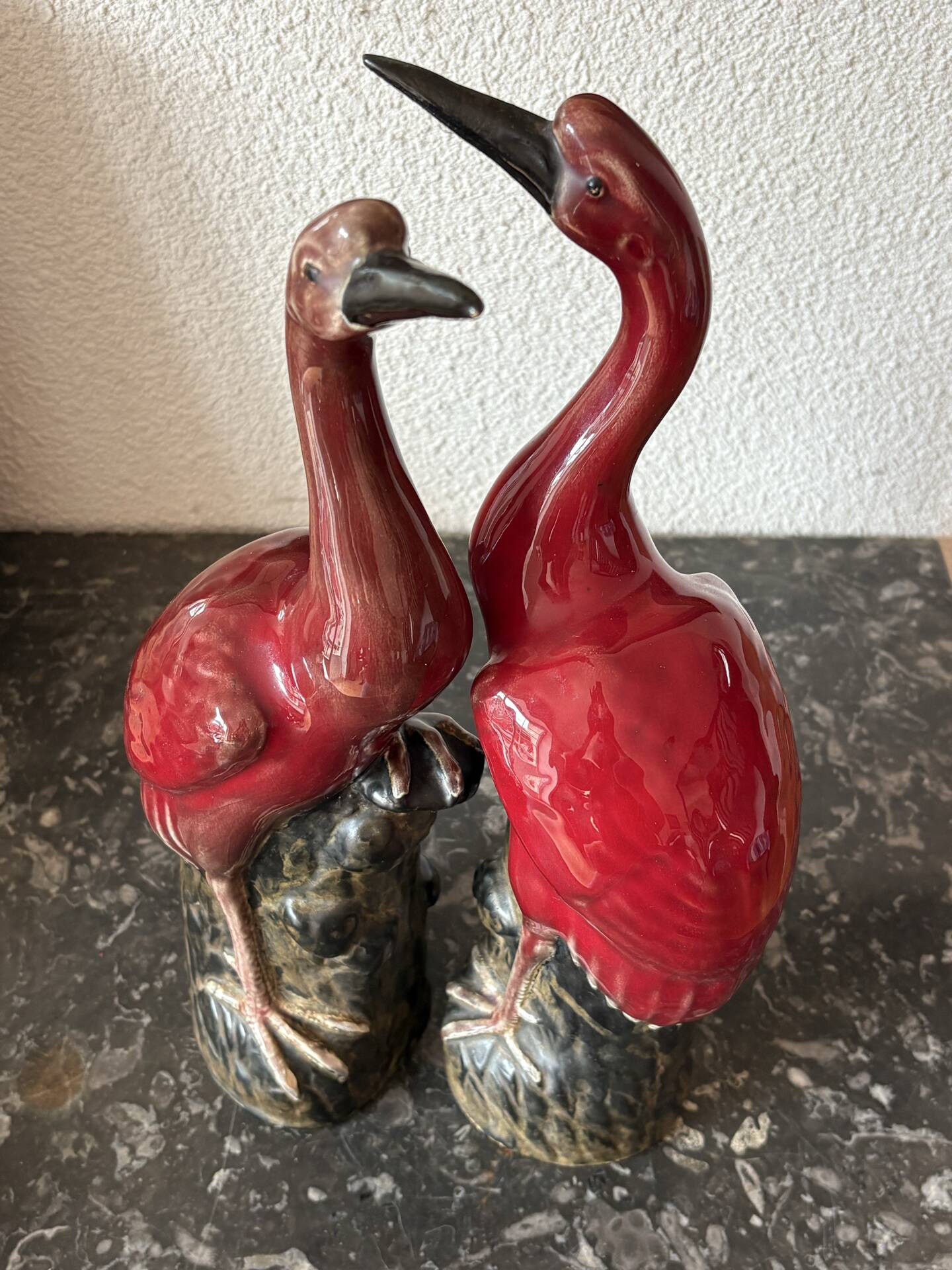Pair of ceramic red glazed wading bird (crane) figurines.