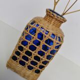 Blue bottle covered with wicker