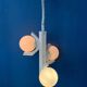 Mid-century white suspension with a bony design and opaline glass shade.