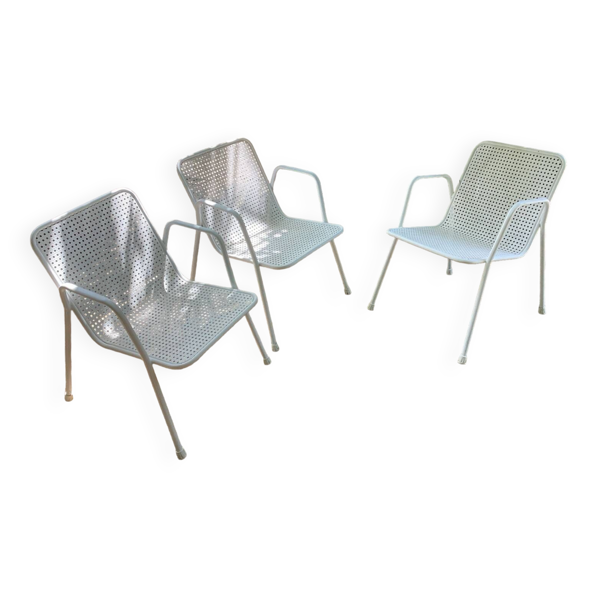 Perforated metal armchairs