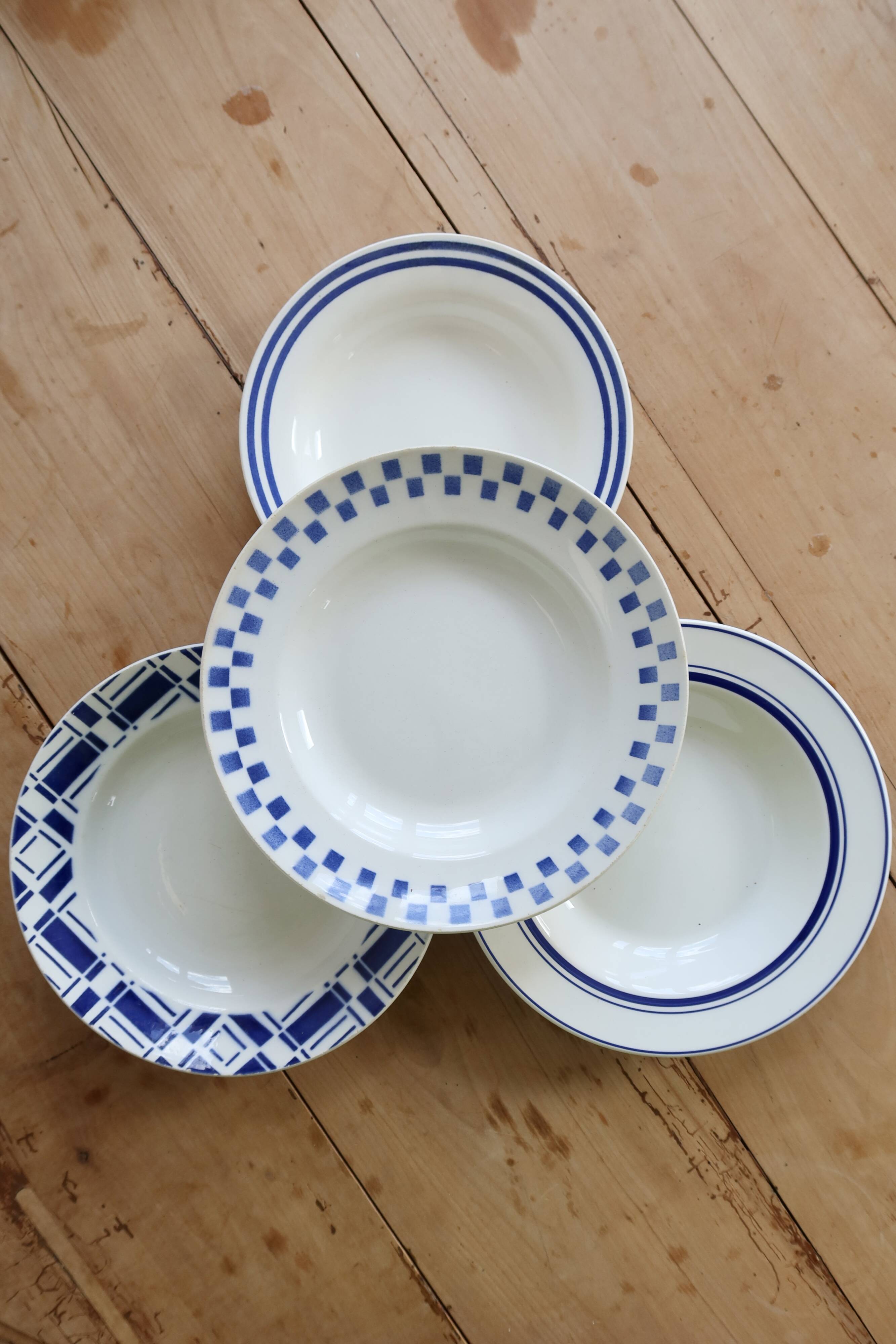 4 mismatched vintage deep plates in blue and white porcelain