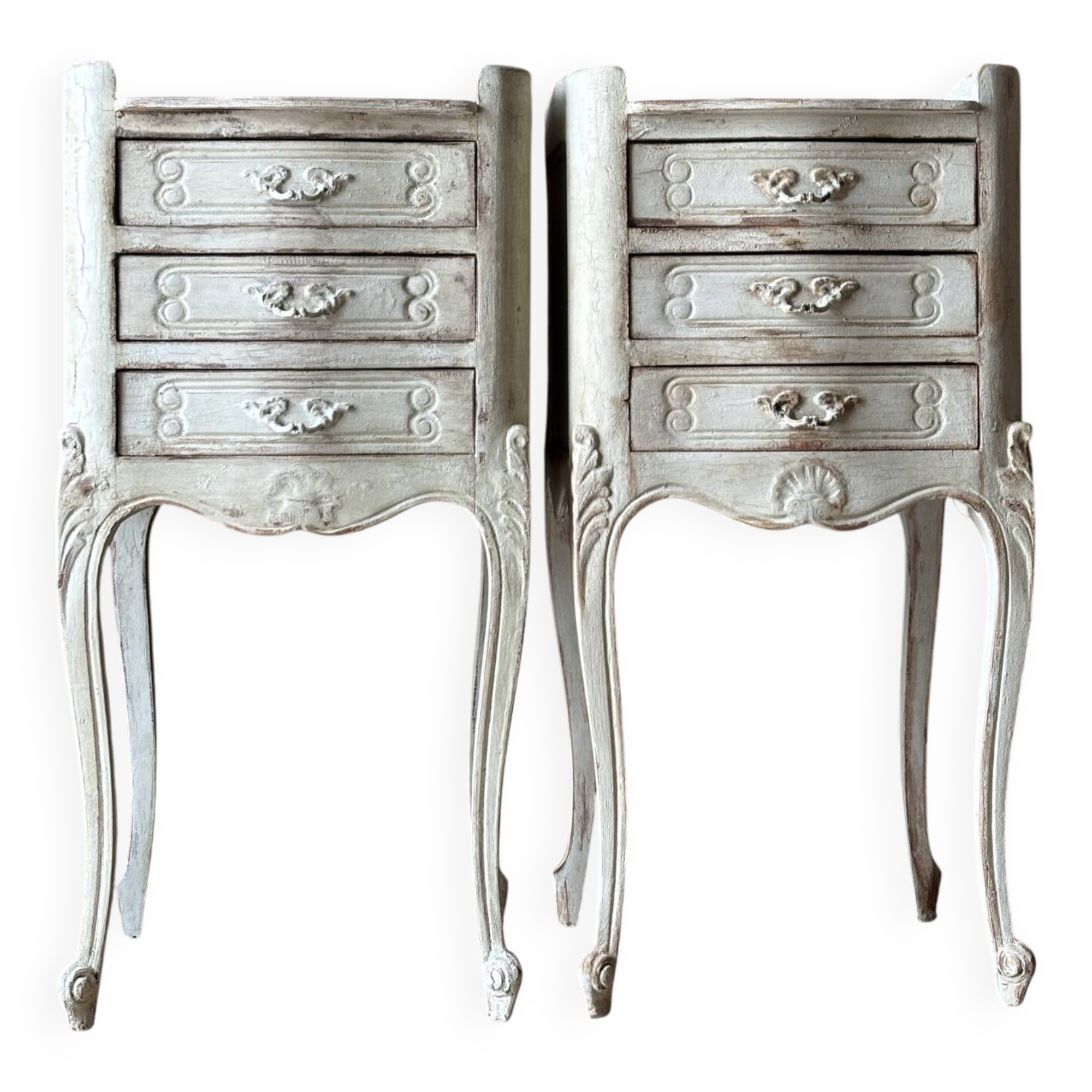 A pair of distressed bedside tables.