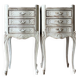 A pair of distressed bedside tables.