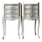 A pair of distressed bedside tables.