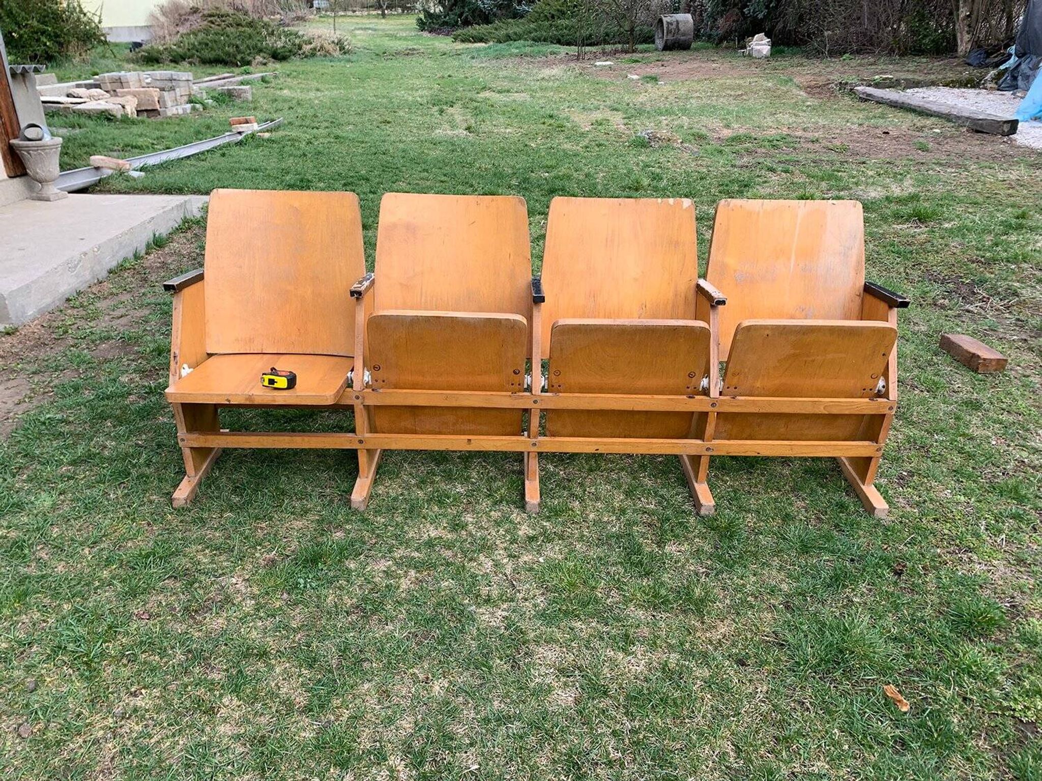 Vintage cinema bench for four people, brown varnished beech in Mid-Century style from the 1950s.