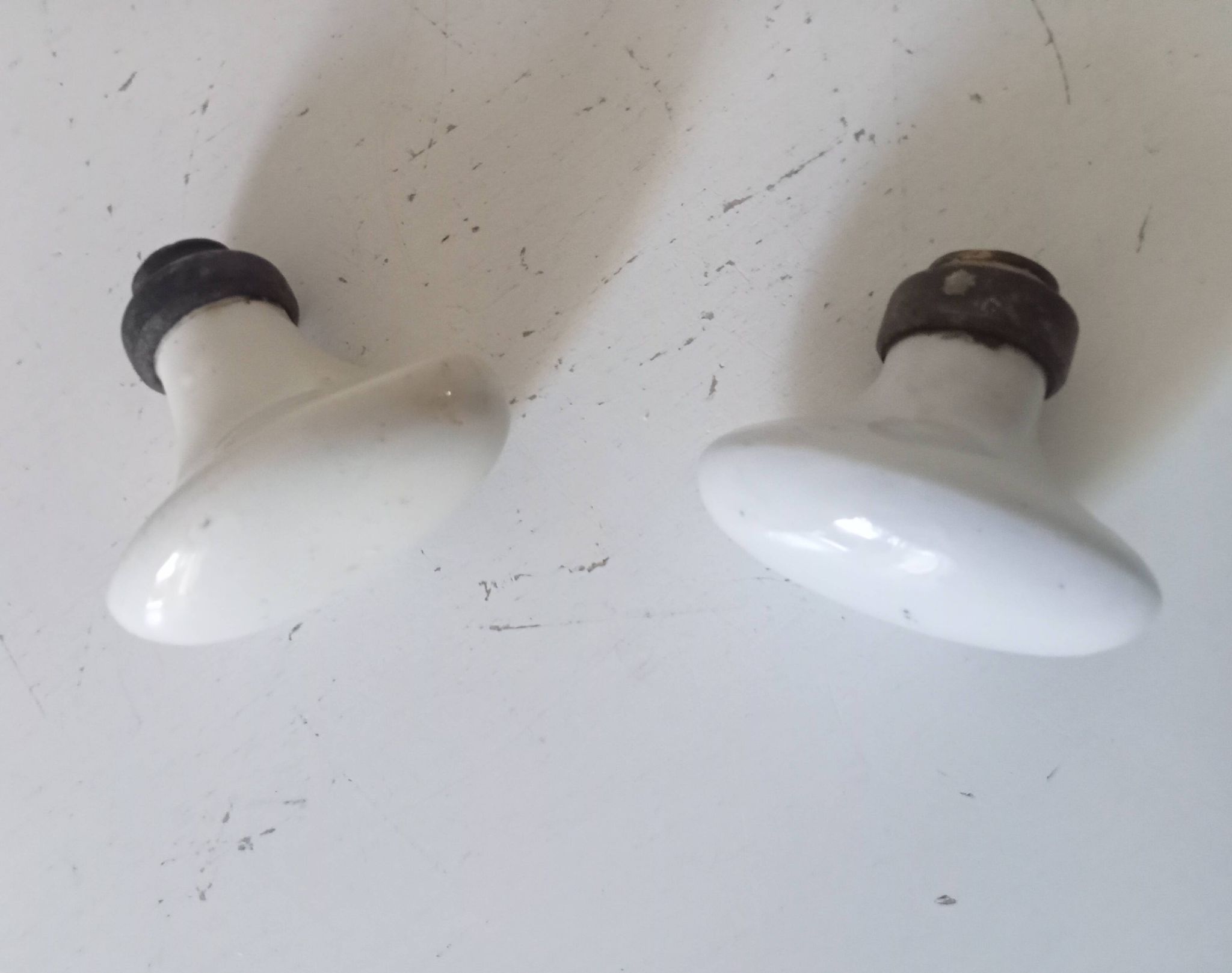 Pair of antique oval door handles in porcelain and brass.