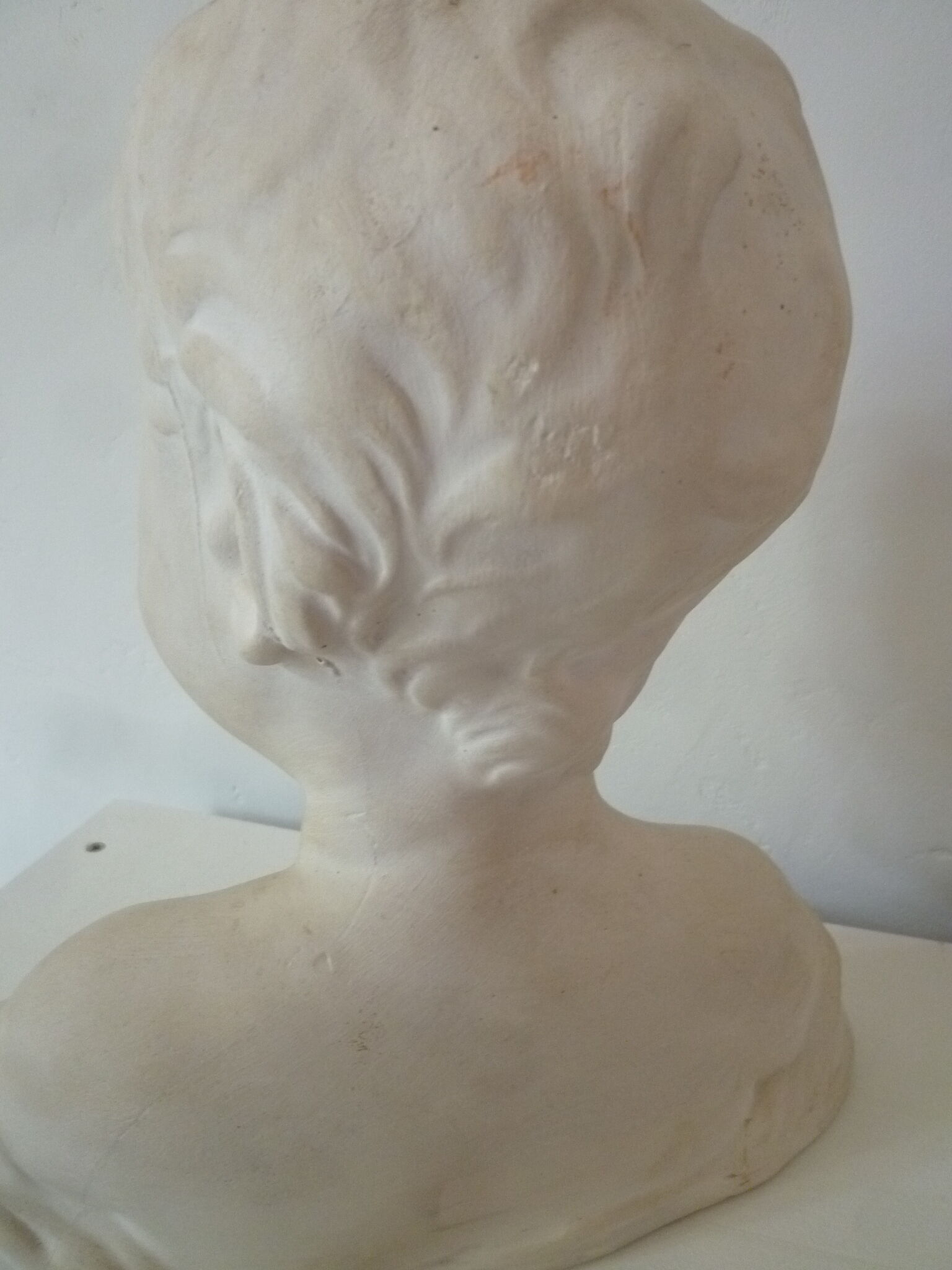 Bust young boy in plaster