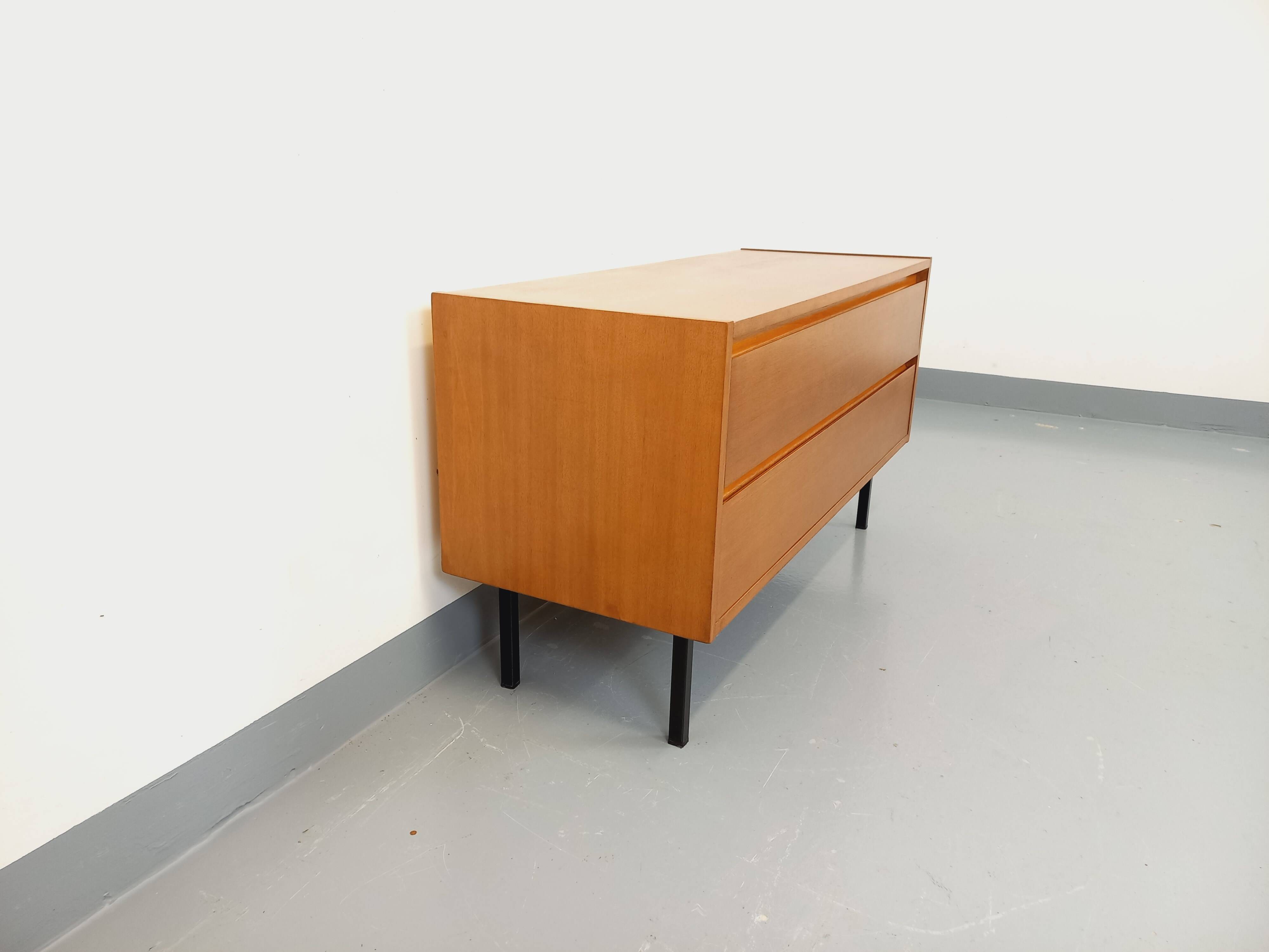 Small vintage Scandinavian sideboard in modernist style made of light oak wood.