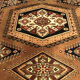 Wool carpet with oriental decoration on a brown background