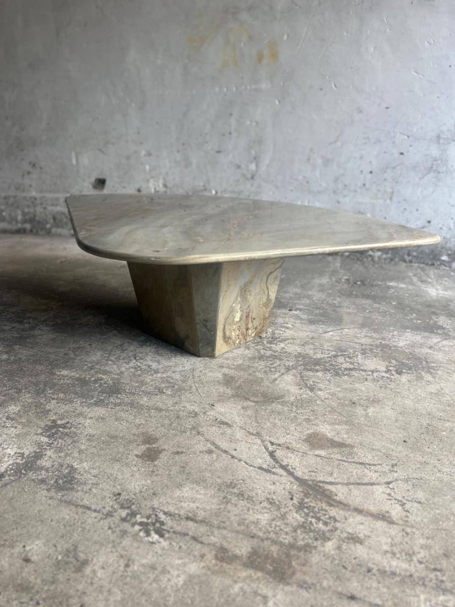 Light gray solid granite coffee table with organic triangular shape and conical base, 1980s