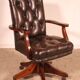 Office chair known as a director's chair in wood and tufted leather.