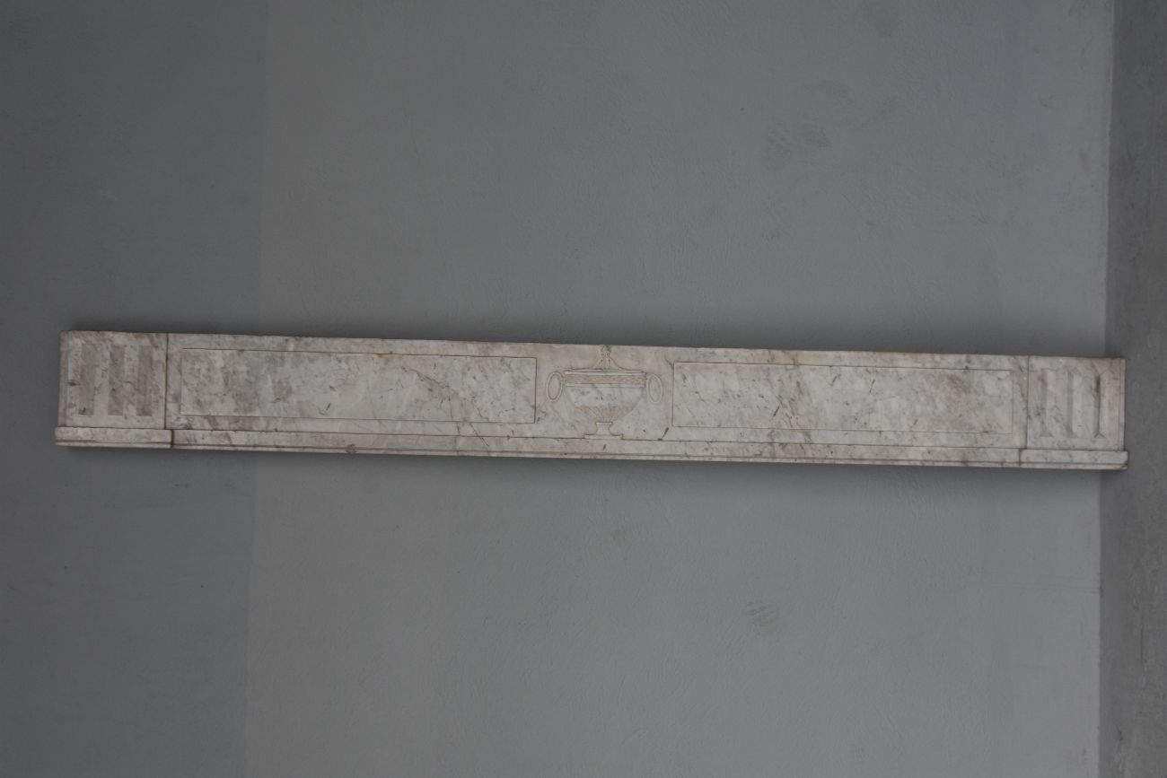 Old fireplace in white marble veined Louis XVI