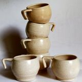 Six vintage potter's ceramic cups with vanilla enamel