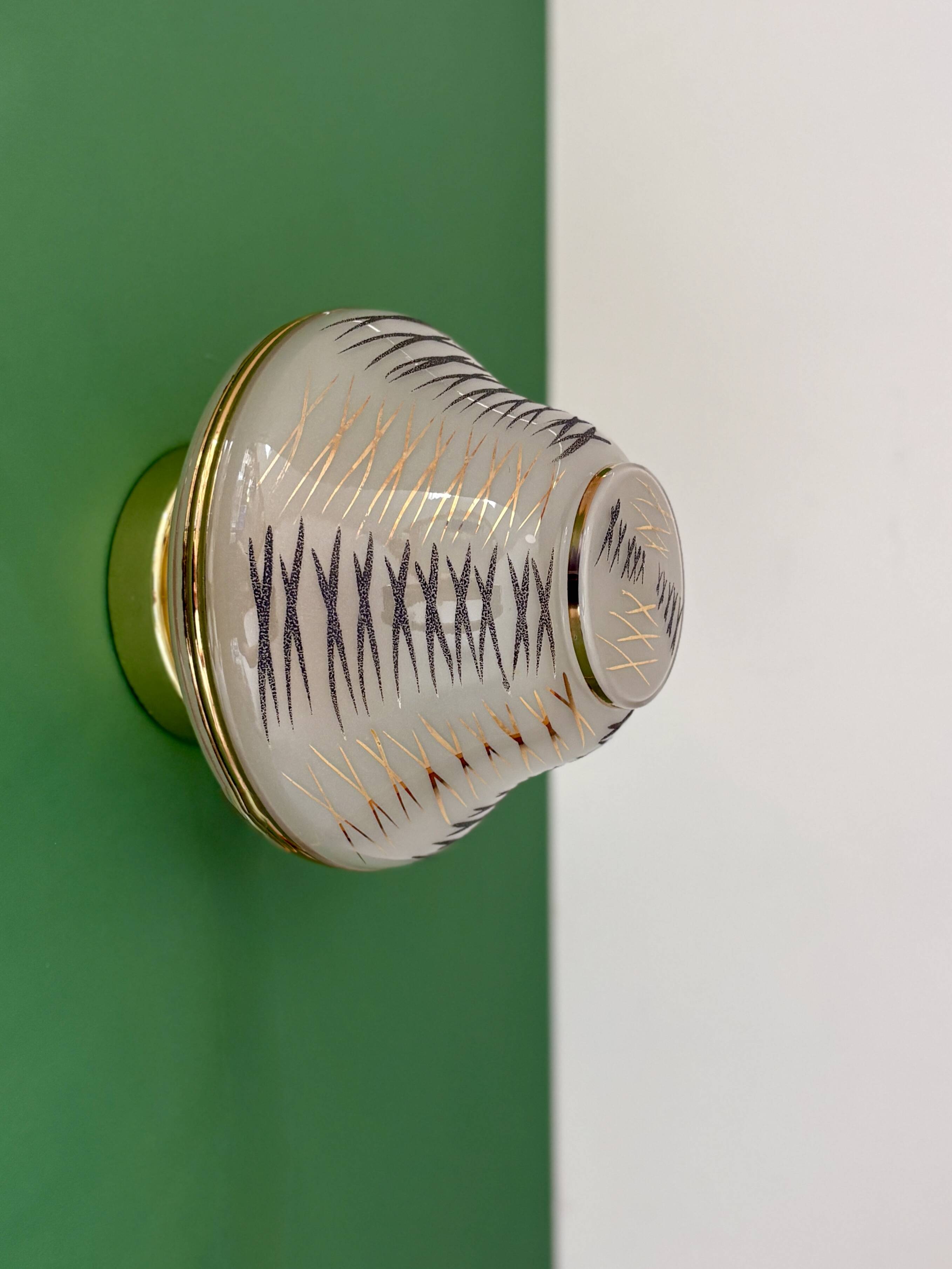 Vintage Art Deco globe wall/ceiling light in white, black, and gold glass.