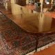 Extensible dining table from the Louis XVI period in mahogany with a banded top.