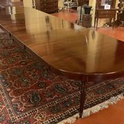 Extensible dining table from the Louis XVI period in mahogany with a banded top.