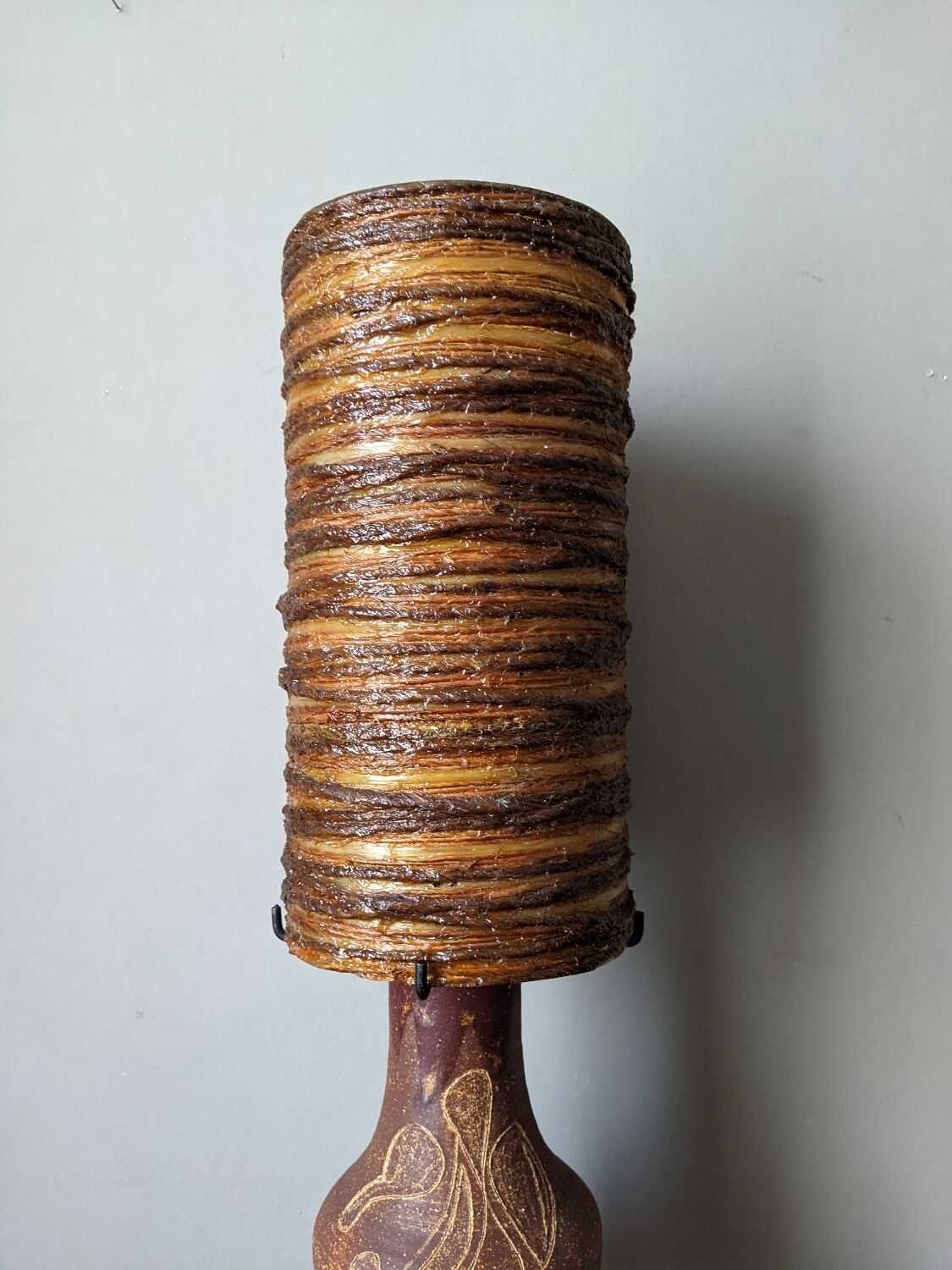 Table lamp with terracotta base and resin shade.