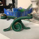 Art Deco candlestick in green and gold earthenware.