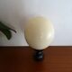 Ostrich egg on blackened wooden base - object of curiosity