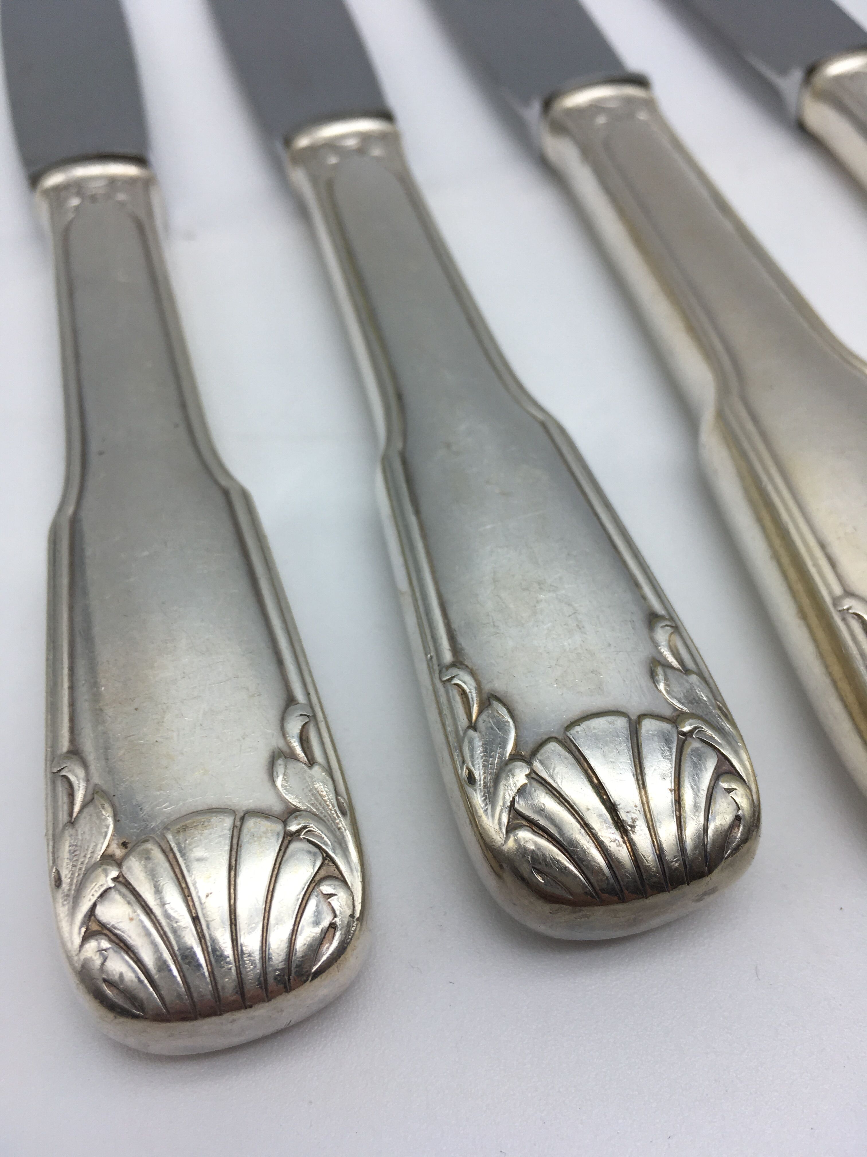 12 silver metal knives.