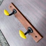 Coat rack with 2 yellow and black hooks