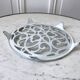 Vintage white cast iron trivet from the early 20th century