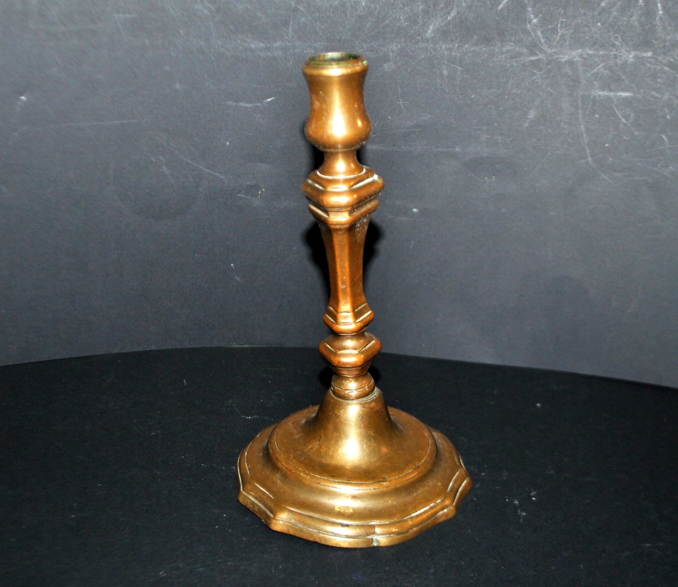 Antique candle holder, carved in bronze, 18th century.