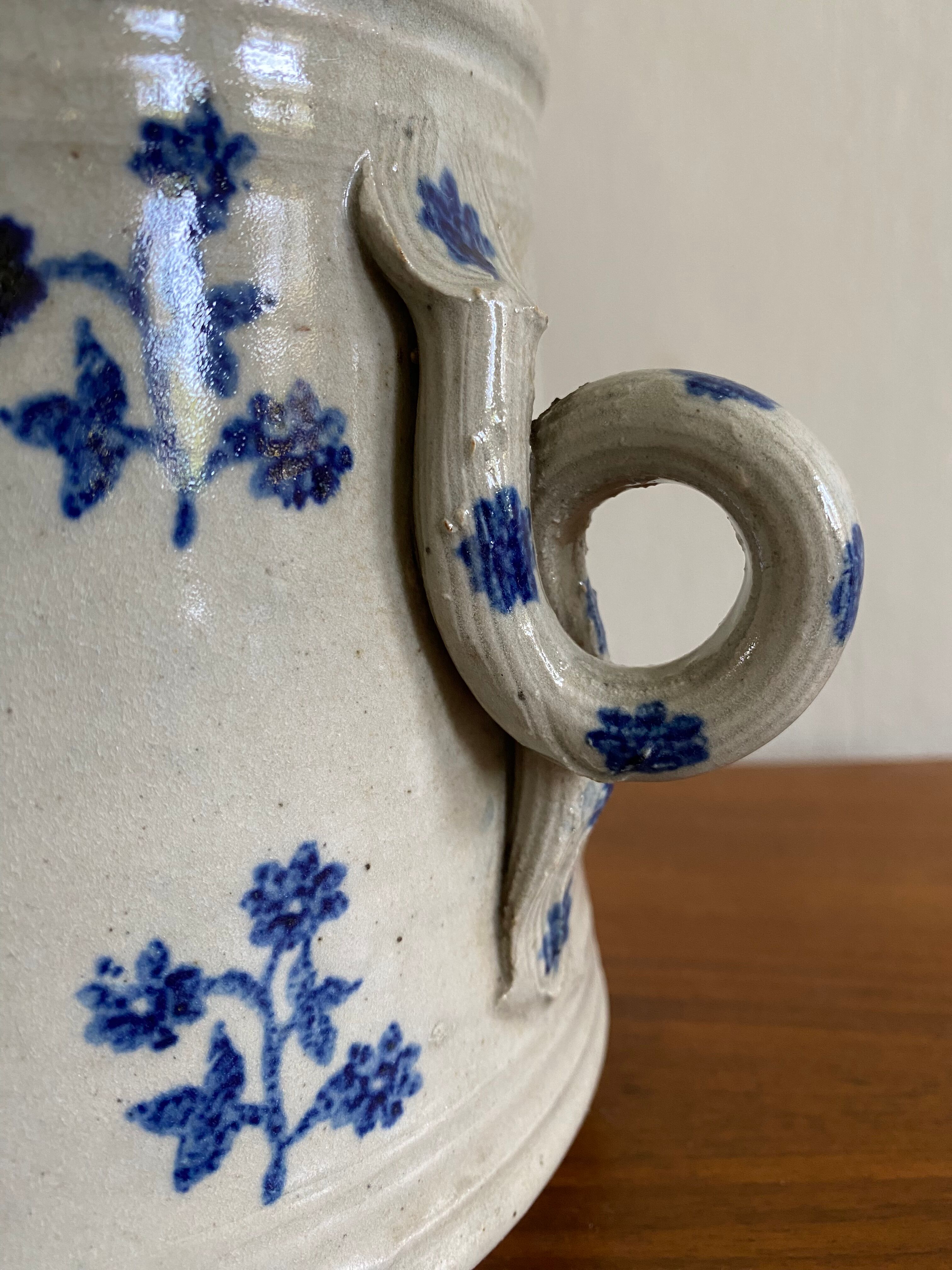Old pot, sandstone, blue flower decoration