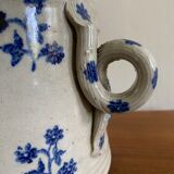 Old pot, sandstone, blue flower decoration