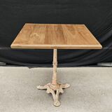 Bistro table with cast iron base and solid teak top