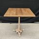 Bistro table with cast iron base and solid teak top