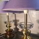 A pair of vintage table lamps featuring a turned wooden base, accessories...