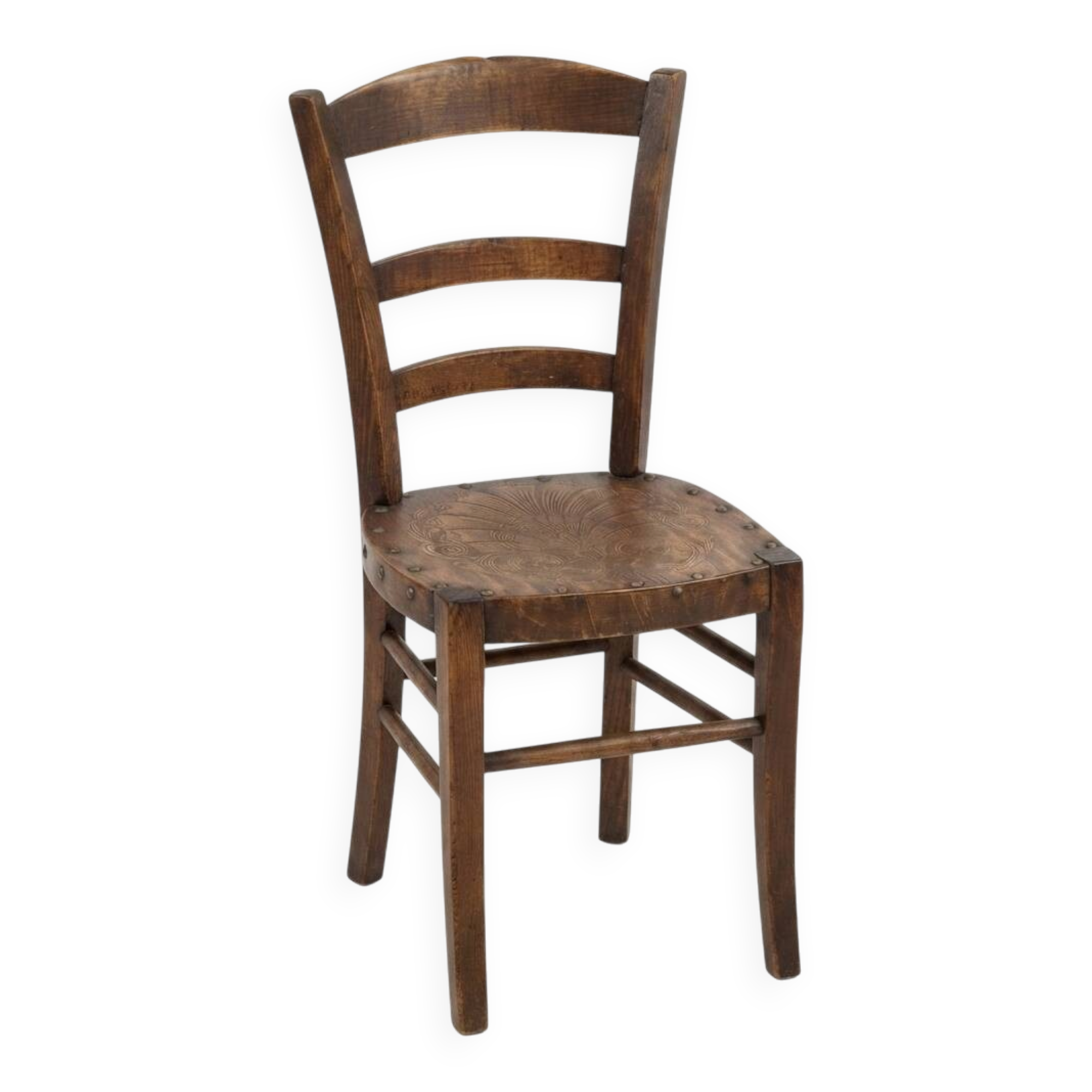 Antique wooden chair with a pyrographed shell motif seat.
