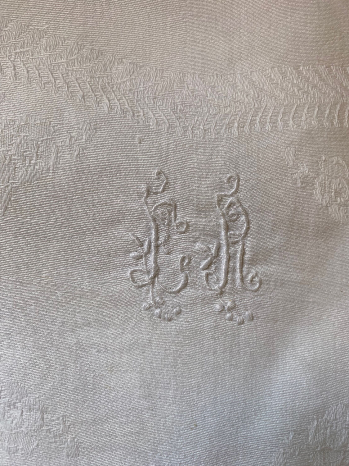 Pair of embroidered white cotton tea towels.