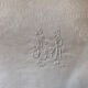 Pair of embroidered white cotton tea towels.